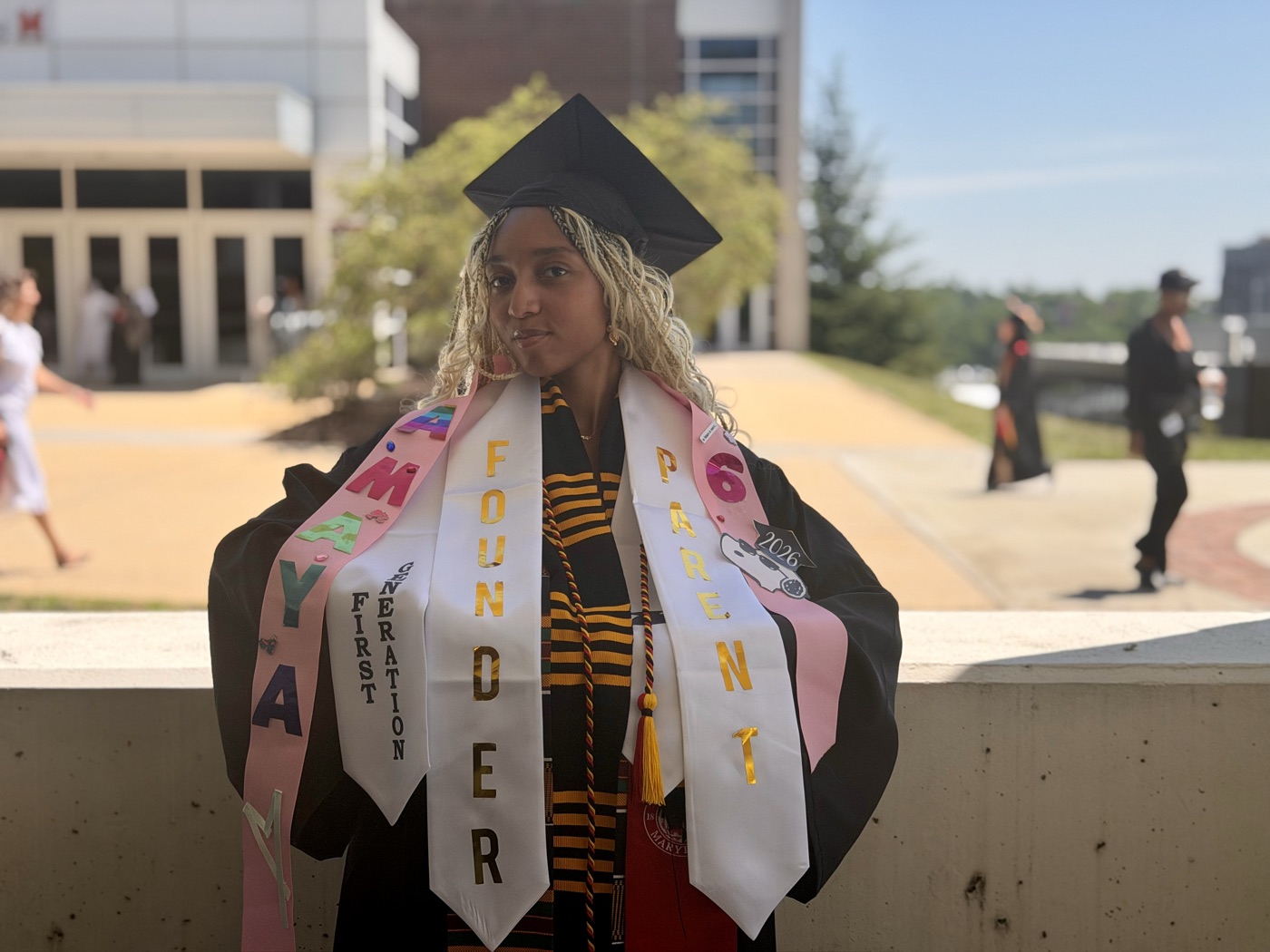 Amaya at her University of Maryland graduation, wearing stoles that read Founder, Student Parent and First Generation
